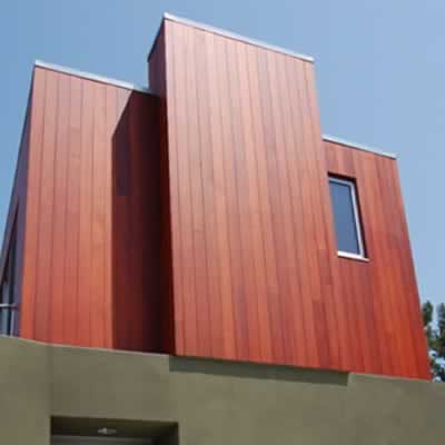 All heartwood redwood siding applied vertically on a modern home.