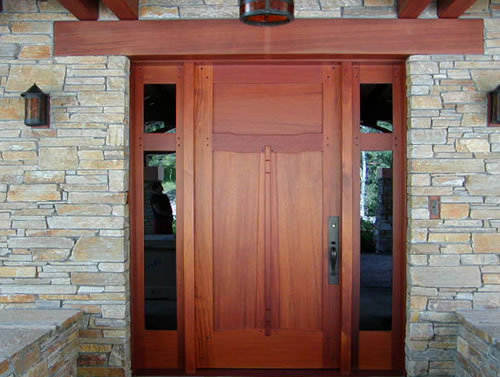 All heartwood redwood siding applied vertically on a modern home.