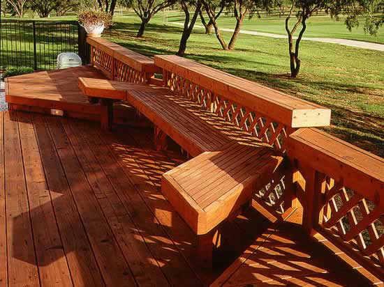 A beautiful redwood deck with built-in bench and retaining wall.