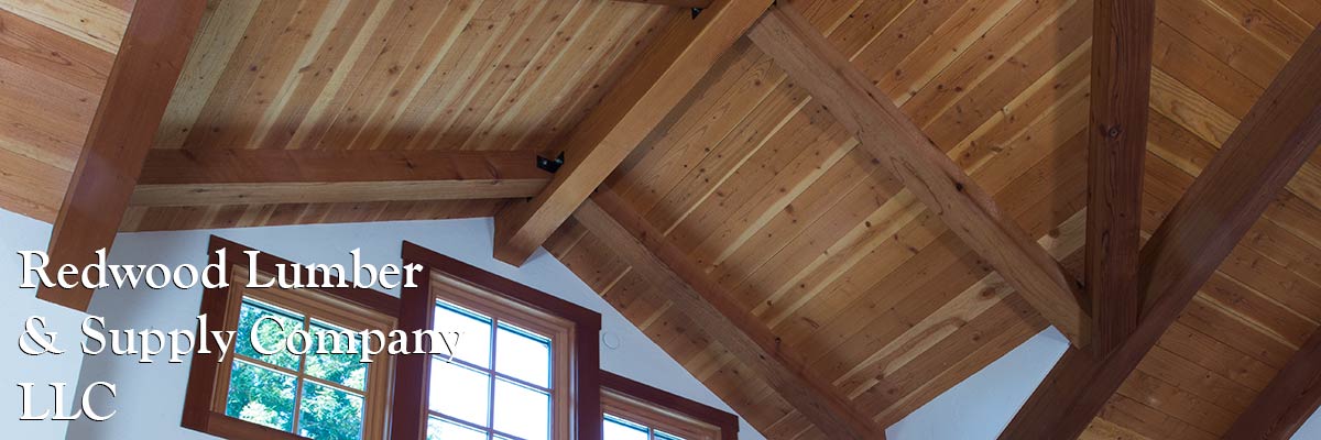 Custom-shaped redwood timbers are used as architectural details in  the roof of a modern home.