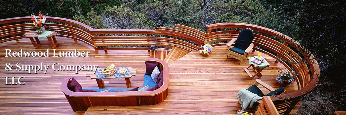 A redwood deck with built-in bench and an elaborate curved rail.